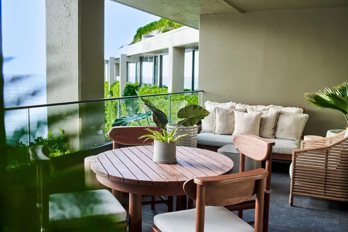 Furnished balcony with ocean and greenery views at 1 Hotel Hanalei Bay.