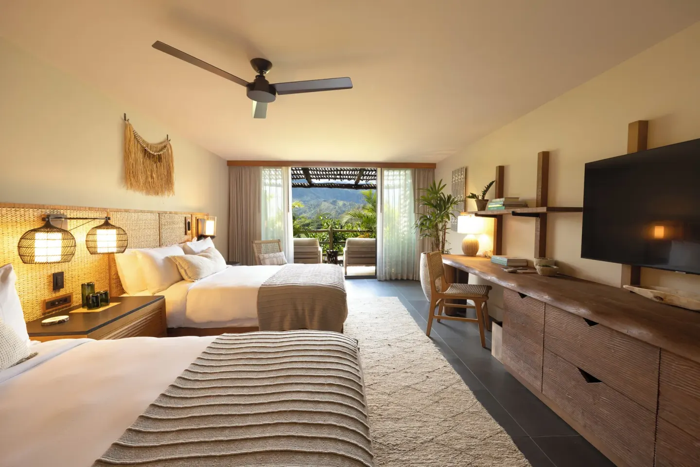 Double-bed guest room with balcony and mountain view at 1 Hotel Hanalei Bay.