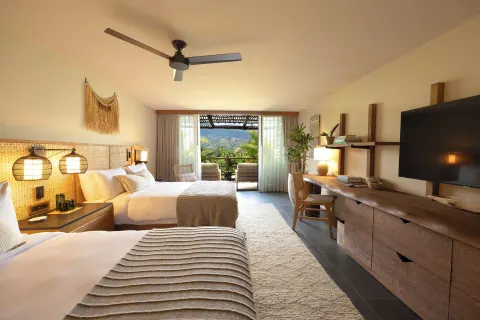 Double-bed guest room with balcony and mountain view at 1 Hotel Hanalei Bay.