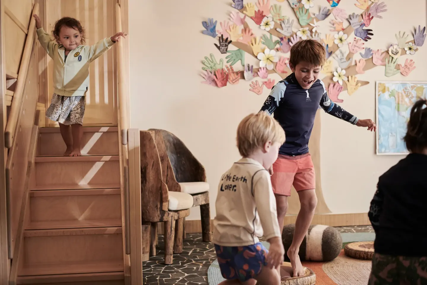 Children playing in a kids room with wooden stairs at 1 Hotel Hanalei Bay.