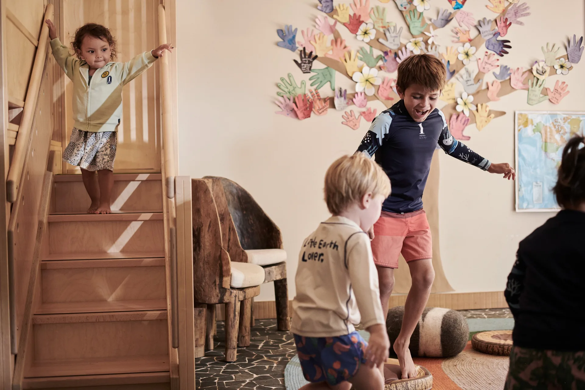 Children playing in a kids room with wooden stairs at 1 Hotel Hanalei Bay.