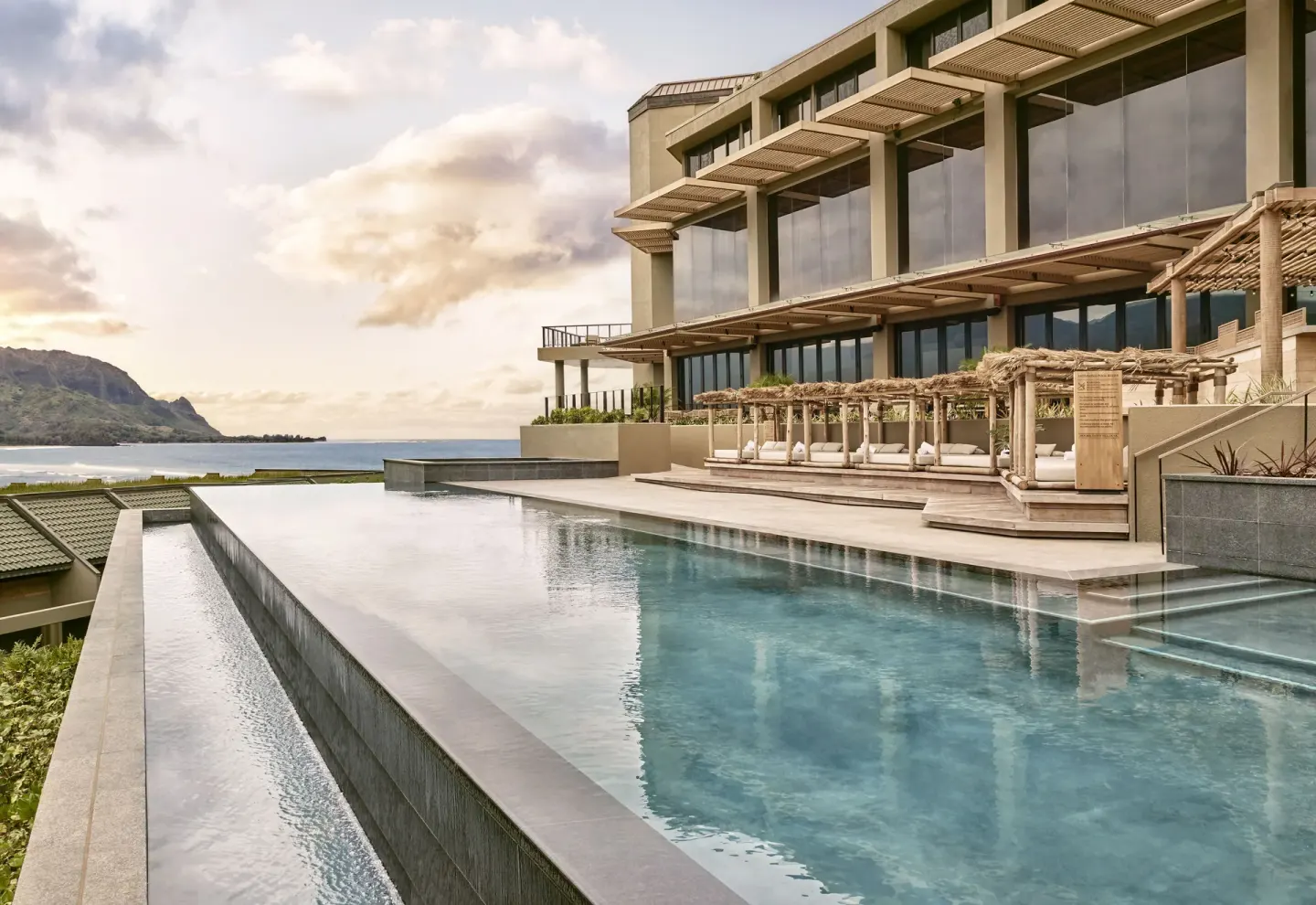 Infinity pool, cabanas, ocean and mountains at 1 Hotel Hanalei Bay.