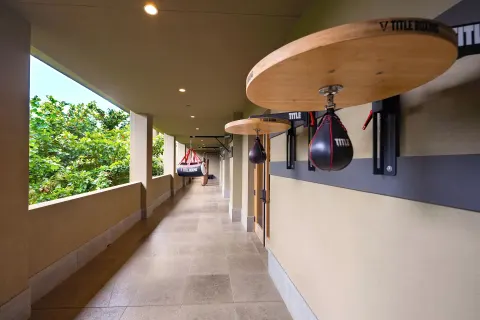 Covered outdoor training corridor with boxing equipment at 1 Hotel Hanalei Bay.
