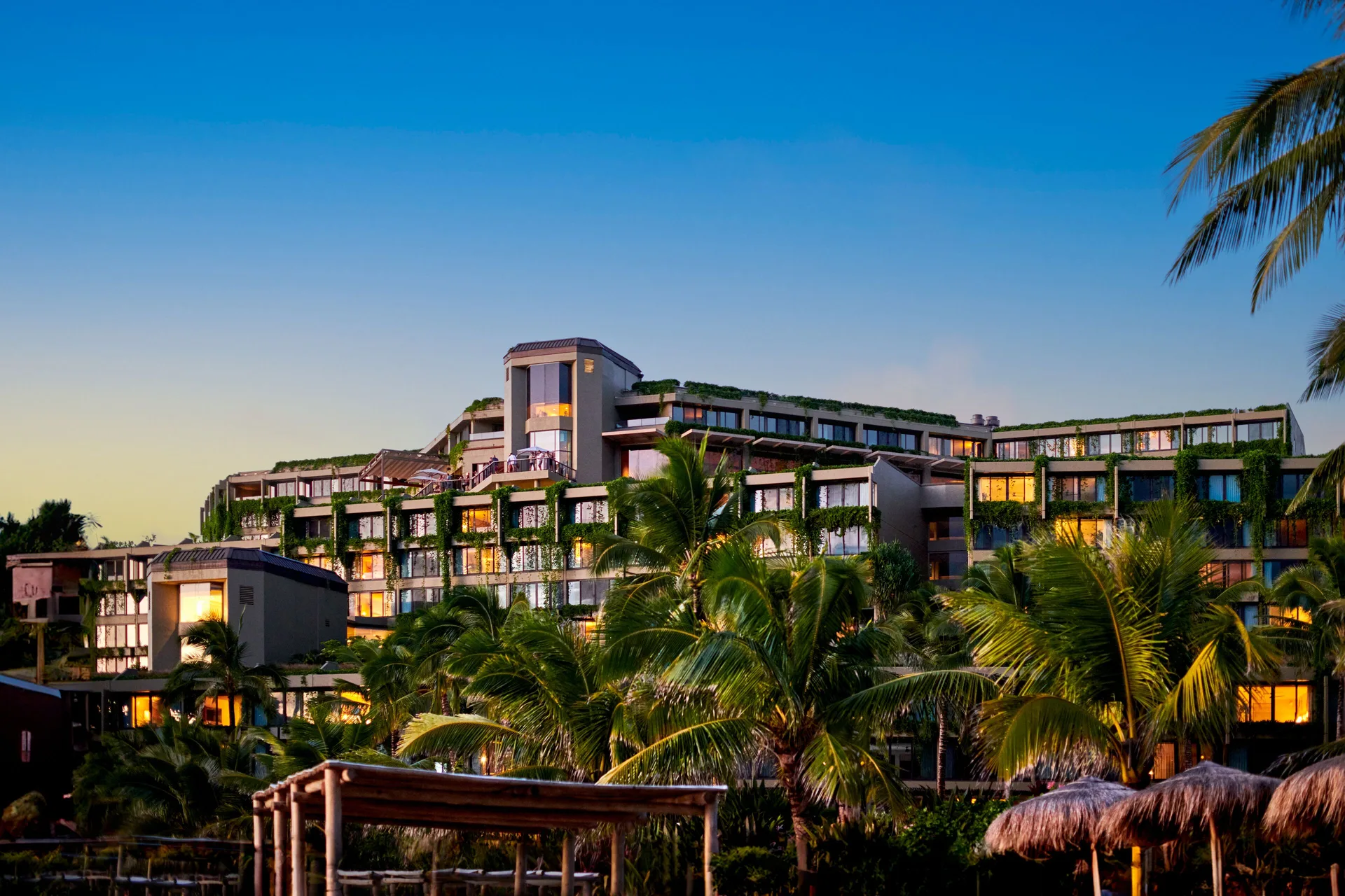 Evening atmosphere at 1 Hotel Hanalei Bay showing intimate outdoor lighting, natural ambiance, and beachfront setting on Kauai's North Shore.