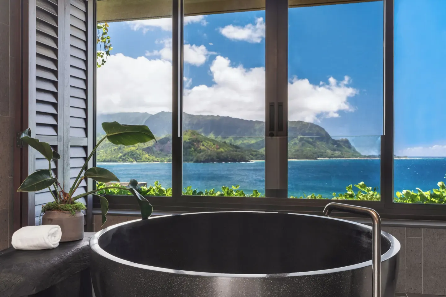 Black soaking tub facing 1 Hotel Hanalei Bay and mountains at 1 Hotel Hanalei Bay.