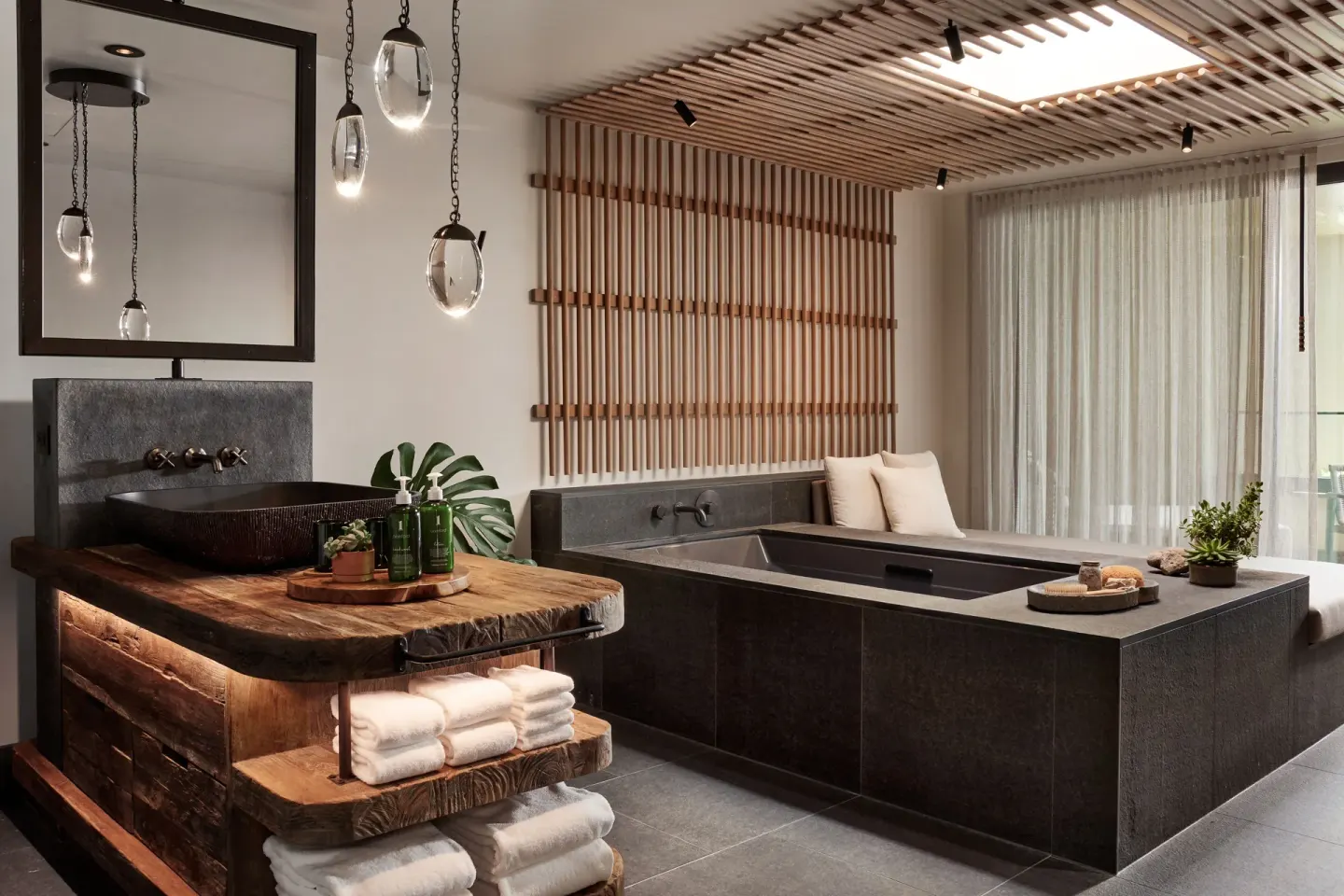 Spa-style bathroom with soaking tub and wood vanity at 1 Hotel Hanalei Bay.