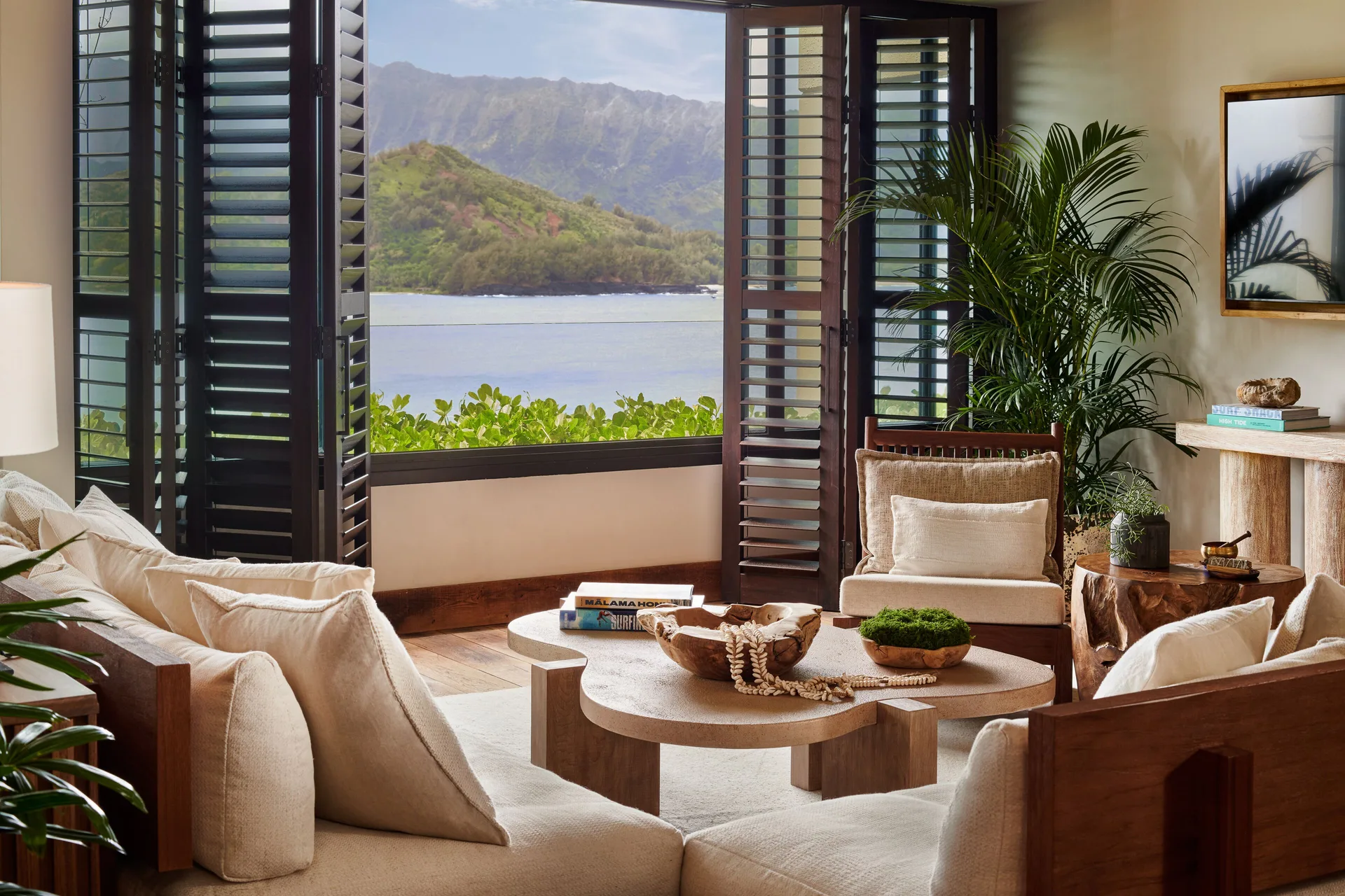 Suite sitting area with shuttered windows framing 1 Hotel Hanalei Bay at 1 Hotel Hanalei Bay.