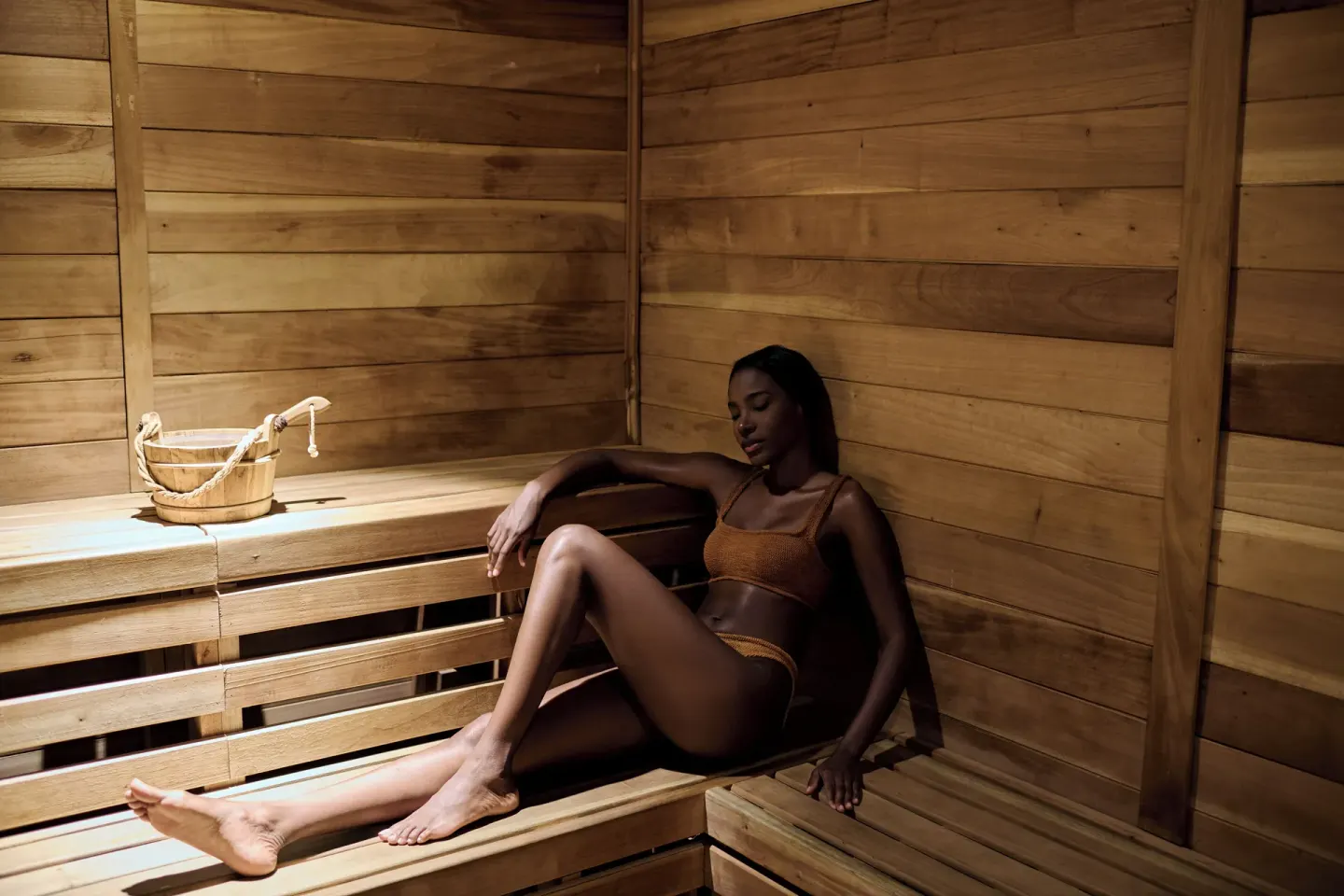Wood-lined sauna with a guest seated on the bench at 1 Hotel Hanalei Bay.