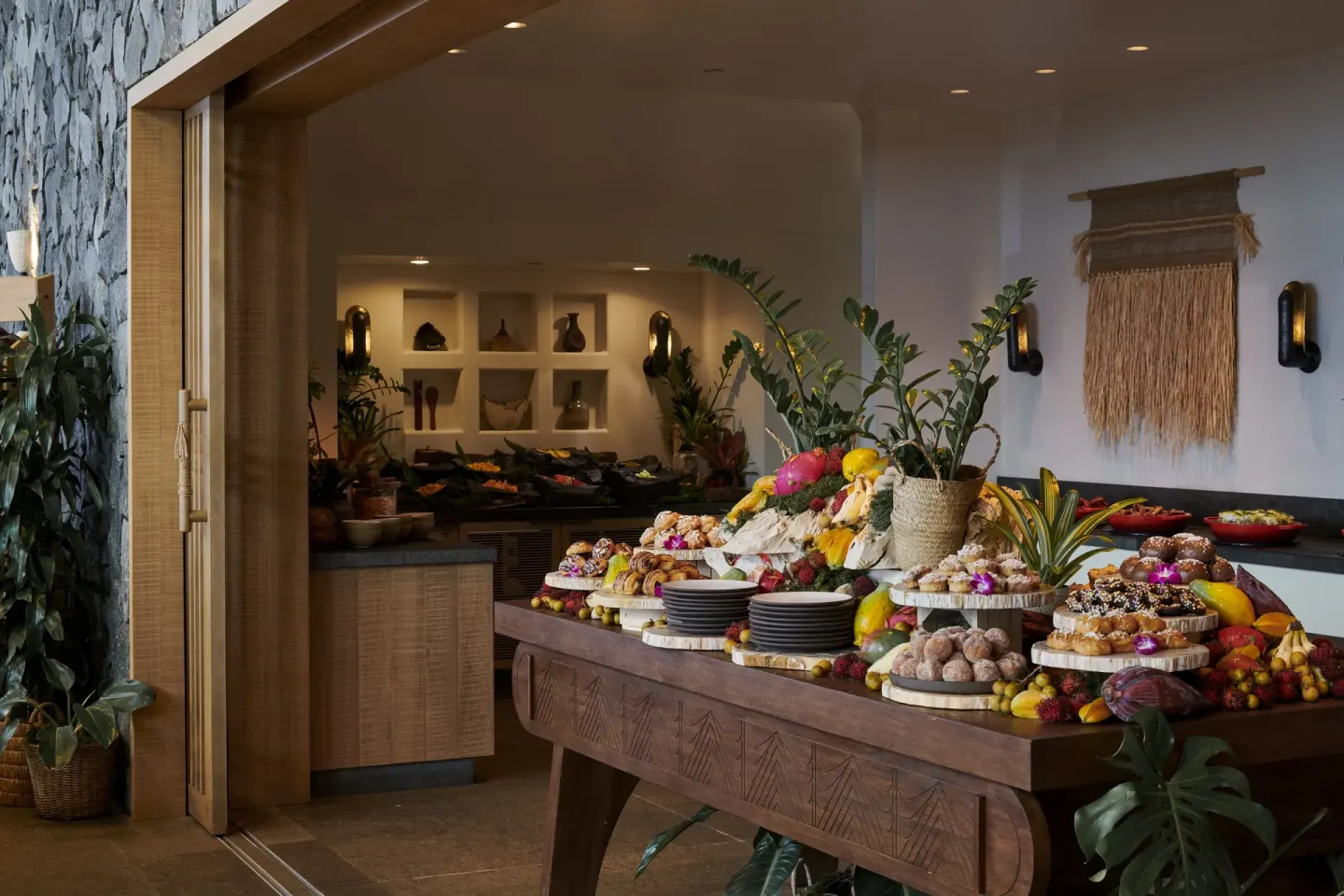 Buffet table with tropical fruit and pastries at 1 Hotel Hanalei Bay.