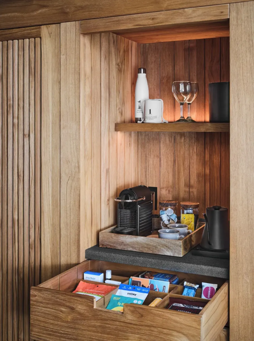 Mountain View guest room refreshment cabinet with coffee maker and snacks at 1 Hotel Hanalei Bay.