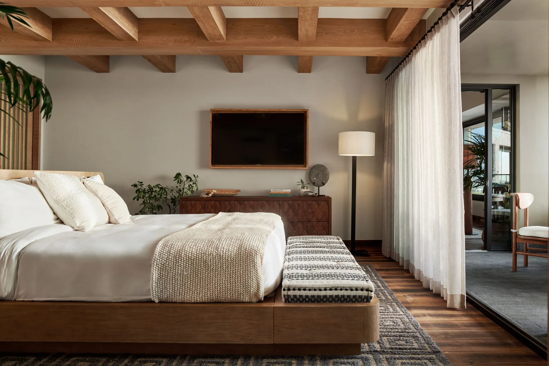 Nāpali House Suite bedroom with king bed and terrace doors at 1 Hotel Hanalei Bay.