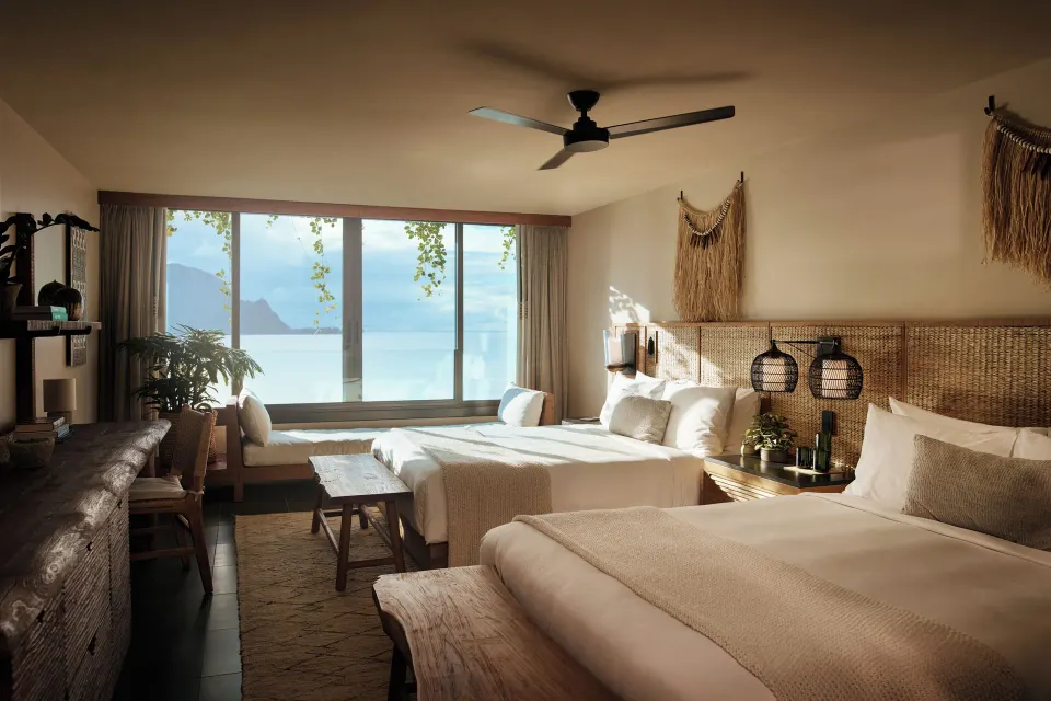Ocean View 2 Queens room with sunlit beds and ocean-facing window at 1 Hotel Hanalei Bay.