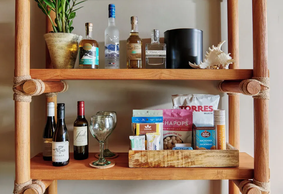 Ocean View Studio Suite minibar shelves with drinks and snacks at 1 Hotel Hanalei Bay.