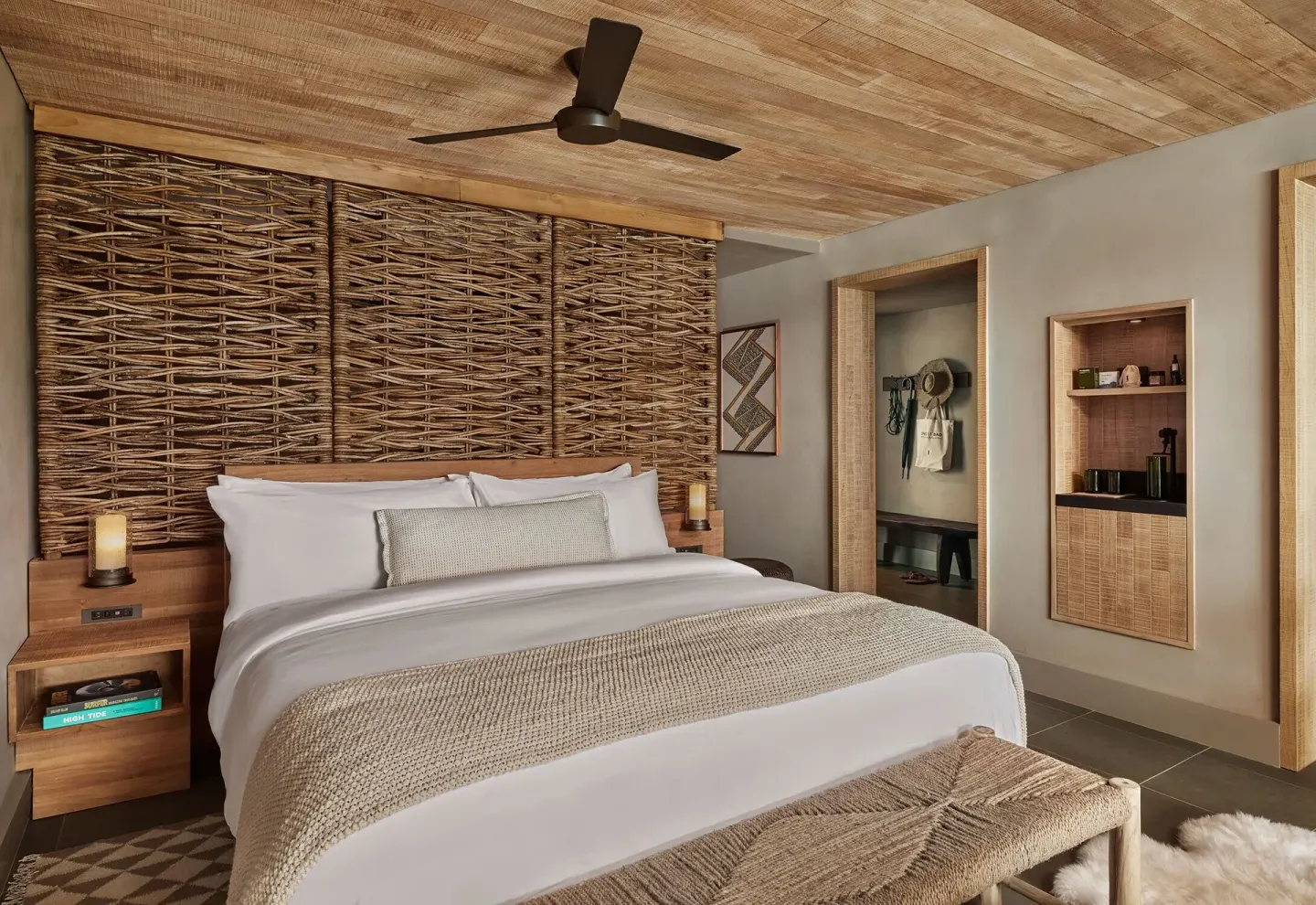 King bed with woven headboard in an Ocean View Terrace Studio Suite at 1 Hotel Hanalei Bay.