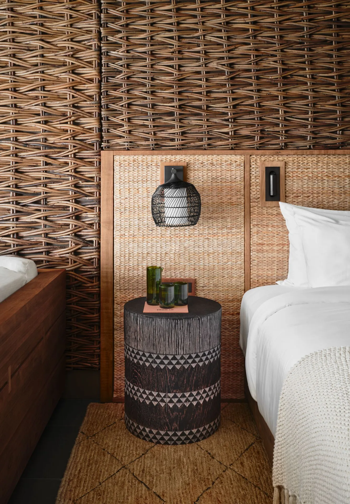 Ocean View Terrace guest room bed and woven wall details at 1 Hotel Hanalei Bay.