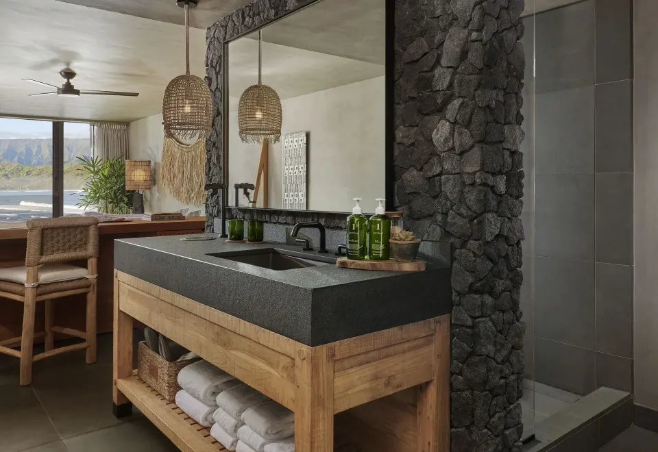Panoramic Ocean View bathroom vanity with stone shower wall at 1 Hotel Hanalei Bay.