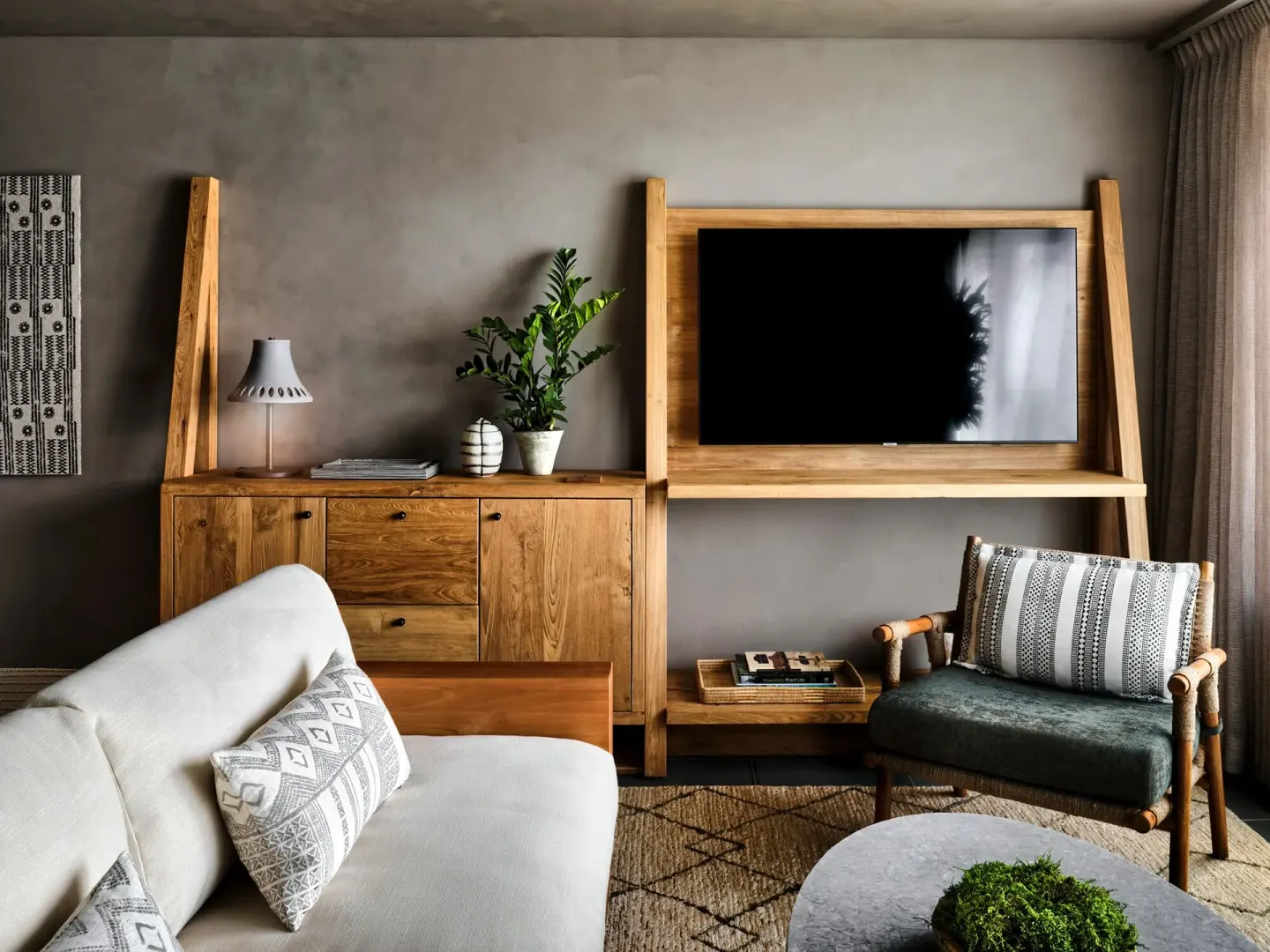 Panoramic Ocean View guest room sitting area with TV and wood furnishings at 1 Hotel Hanalei Bay.