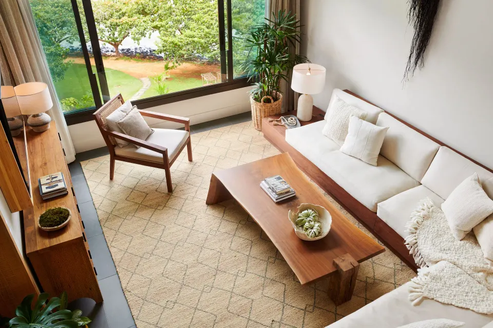 Pu'u Poa Ocean Loft Suite living room with sofa and garden view at 1 Hotel Hanalei Bay.