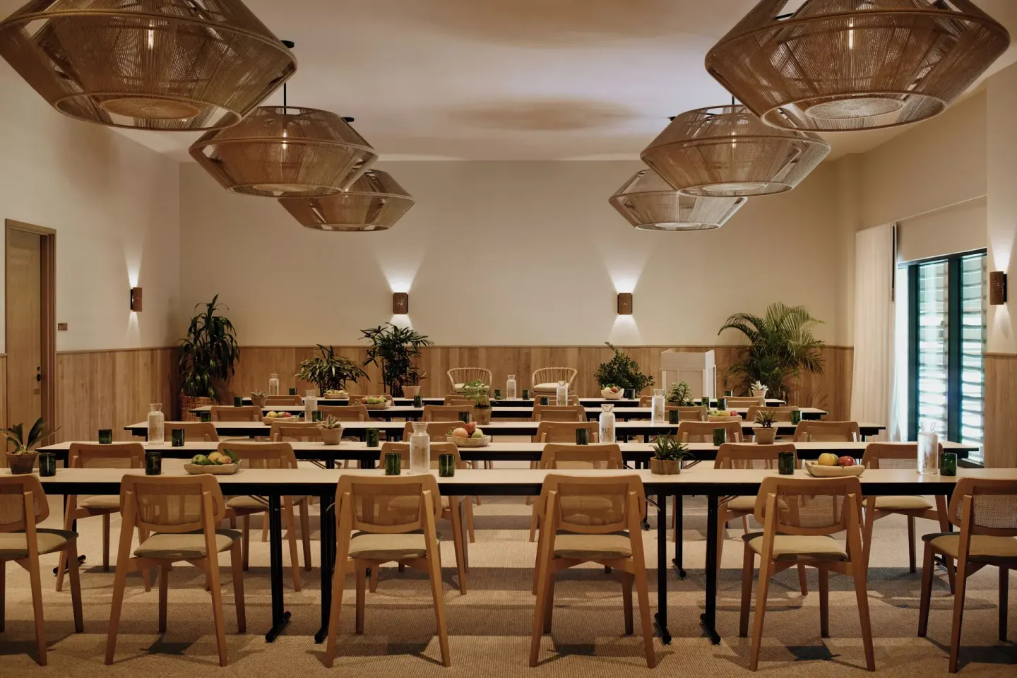 Meeting room with long tables and woven pendant lights at 1 Hotel Hanalei Bay.