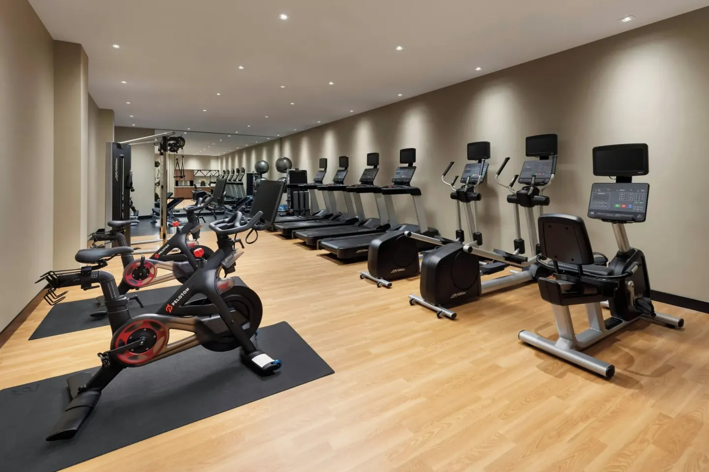Fitness center with cardio machines, bikes and strength equipment at AC Hotel Honolulu.