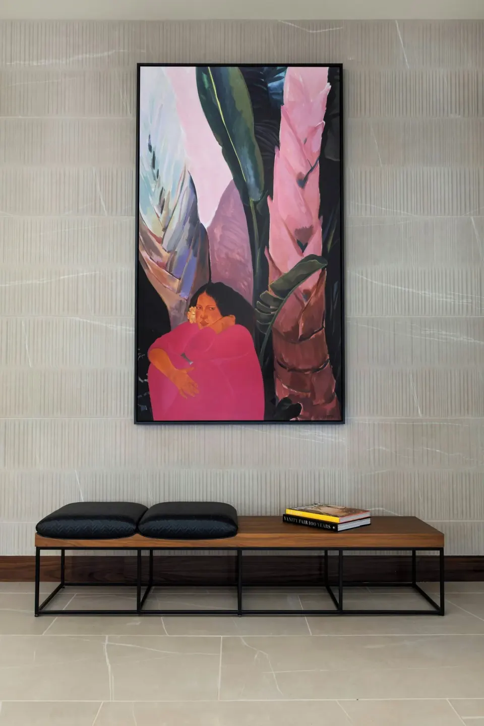 Framed tropical artwork above a bench in the lobby at AC Hotel Honolulu.