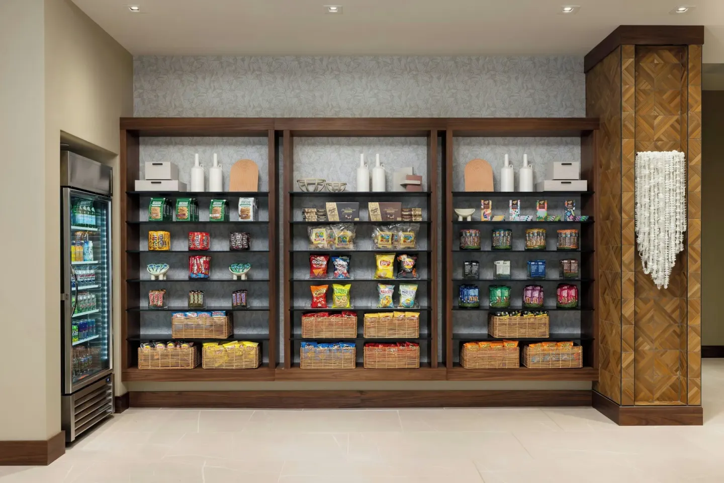 Market shelves with snacks and a beverage refrigerator at AC Hotel Honolulu.