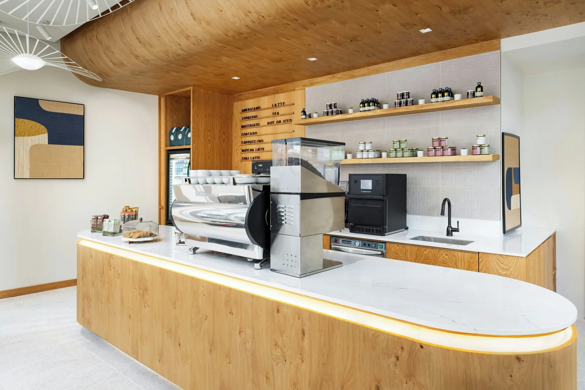 Coffee counter with espresso machine, menu board and shelves at AC Hotel Honolulu.