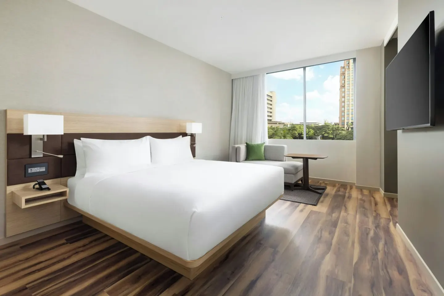 City View Larger king guest room with window seating at AC Hotel Honolulu.