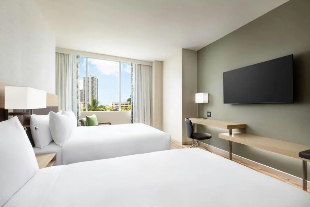 City View double queen room with TV, desk, and window at AC Hotel Honolulu.