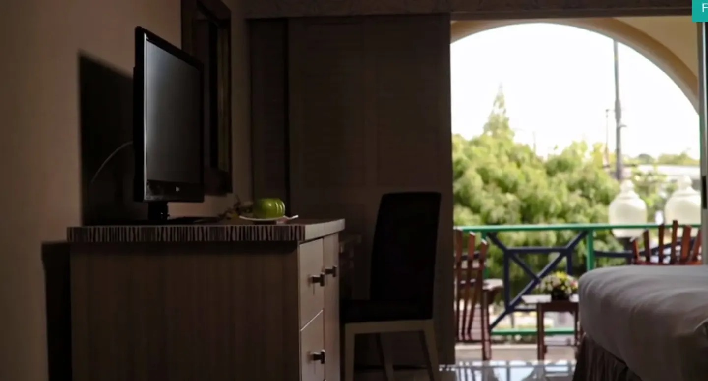 Guest room dresser, TV and balcony doorway at Accra Beach Hotel & Spa.