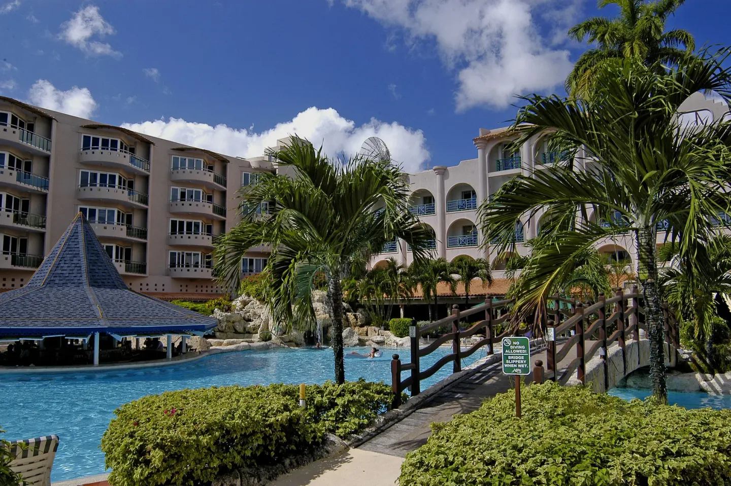 Pool bridge, palms and waterfall beside the hotel at Accra Beach Hotel & Spa.