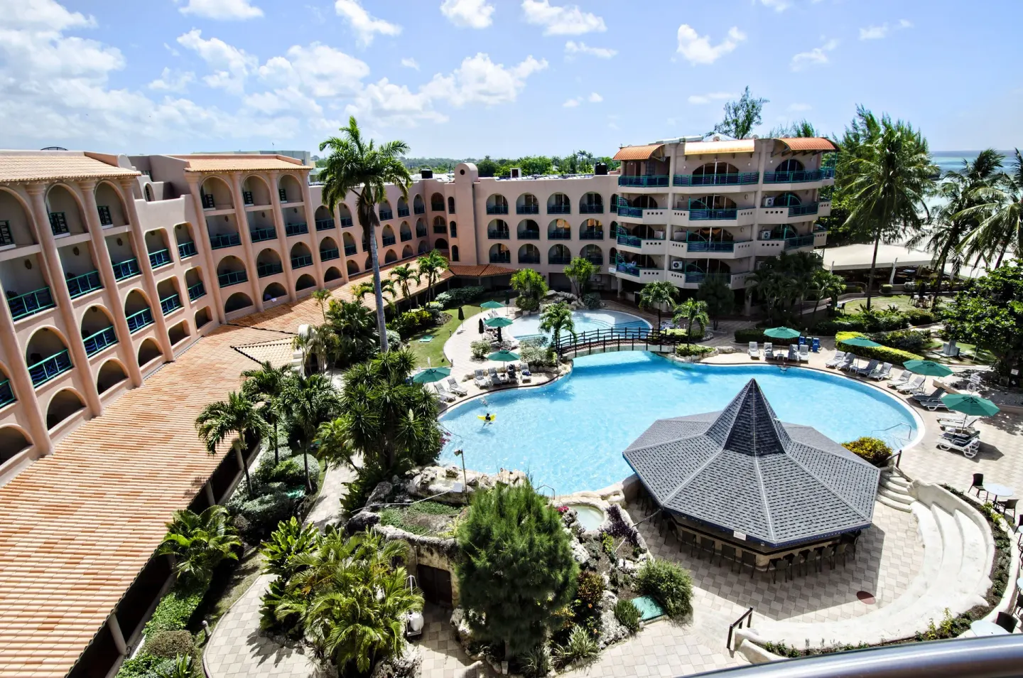 Elevated view of the pool courtyard and guestroom wings at Accra Beach Hotel & Spa.