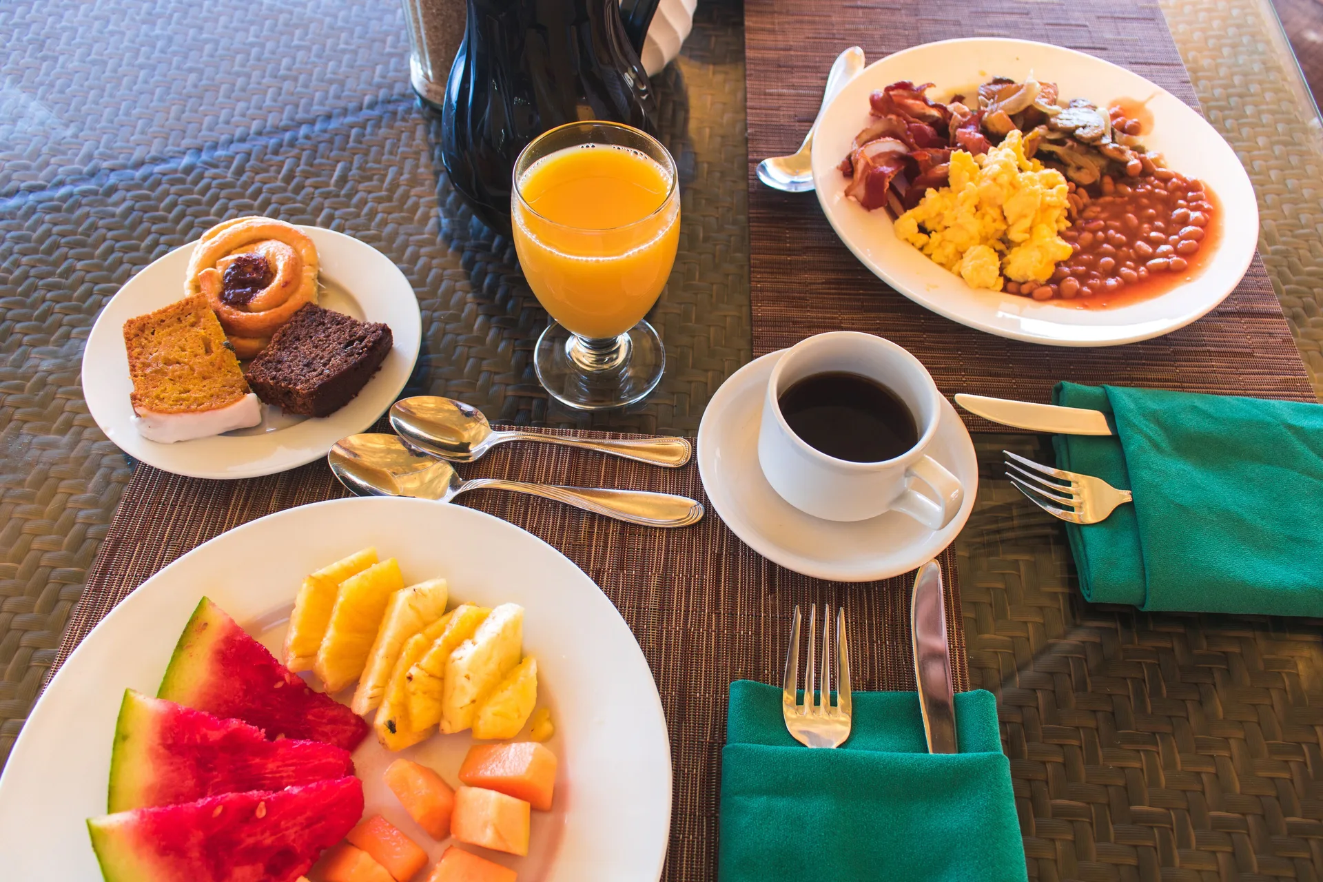 Breakfast plates with fruit, pastries, coffee, and hot items at Accra Beach Hotel & Spa.
