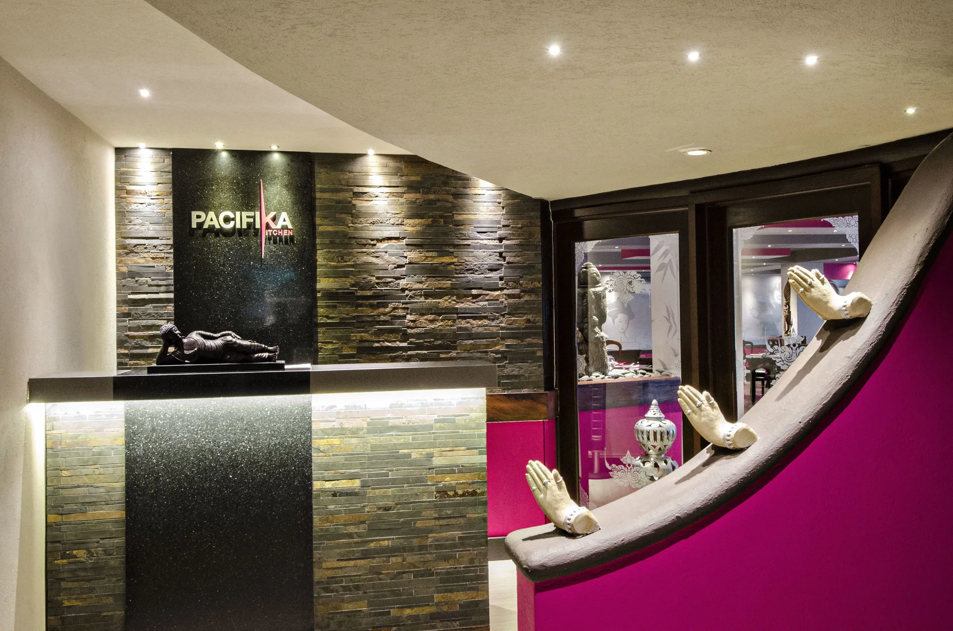 Pacifika Kitchen entrance with stone wall and sculptural decor at Accra Beach Hotel & Spa.