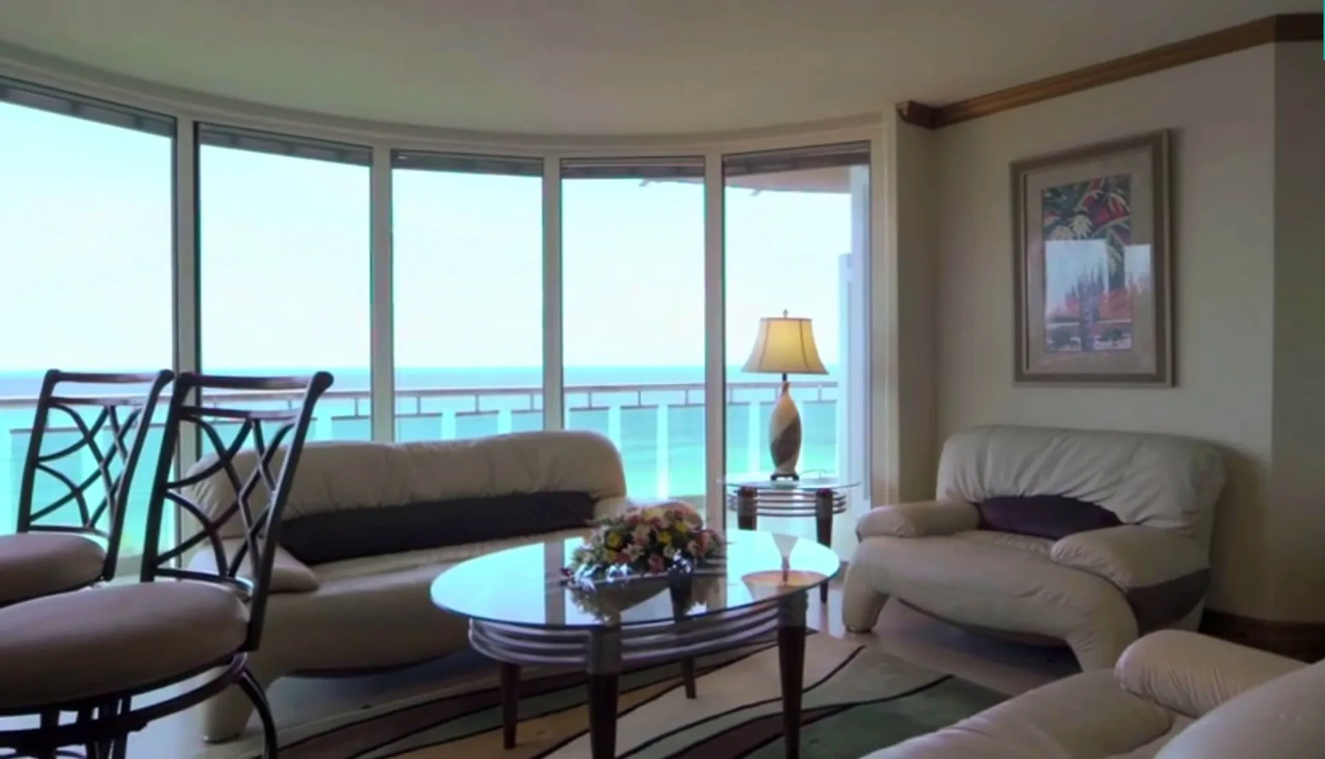 Ocean-view sitting room in a Luxury Oceanfront Suite at Accra Beach Hotel & Spa with sofas and balcony windows.