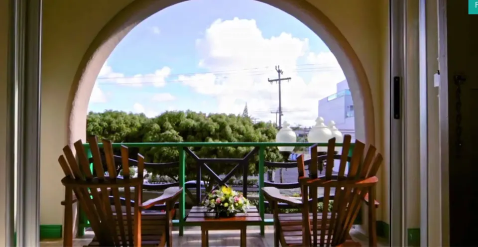 Island View balcony with chairs and island scenery at Accra Beach Hotel & Spa.