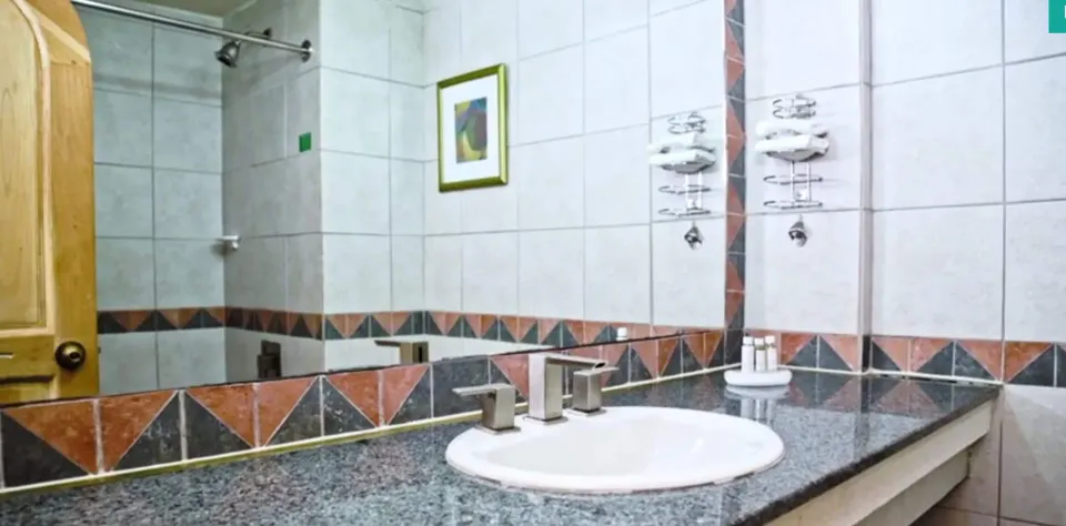 Island View room bathroom vanity and shower at Accra Beach Hotel & Spa.