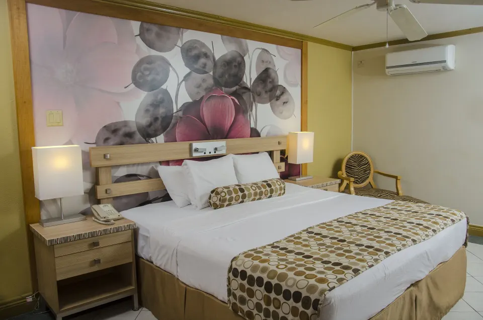 Island View king bed with floral wall art at Accra Beach Hotel & Spa.