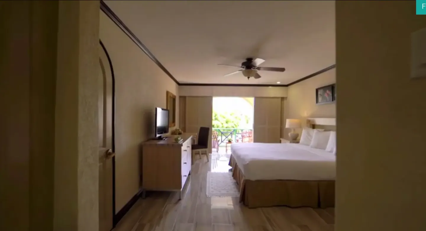Island View guest room with bed, TV, and balcony at Accra Beach Hotel & Spa.
