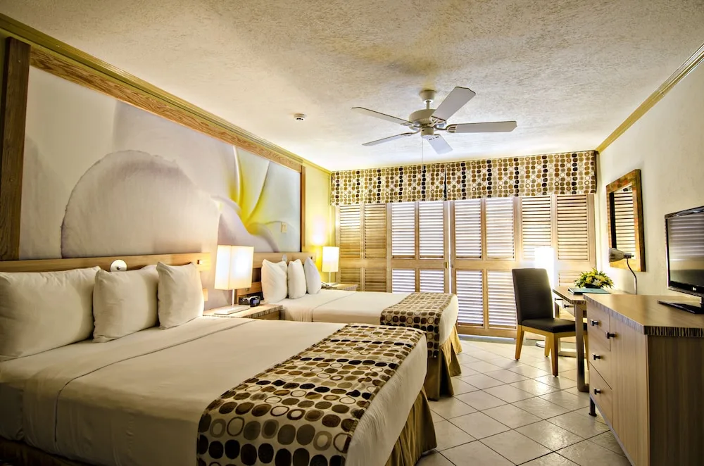 Oceanfront guest room with two double beds at Accra Beach Hotel & Spa.