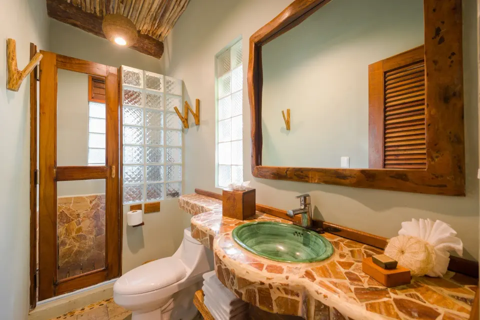 Bathroom sink, toilet and vanity area in Junior Suite at Ahau Tulum