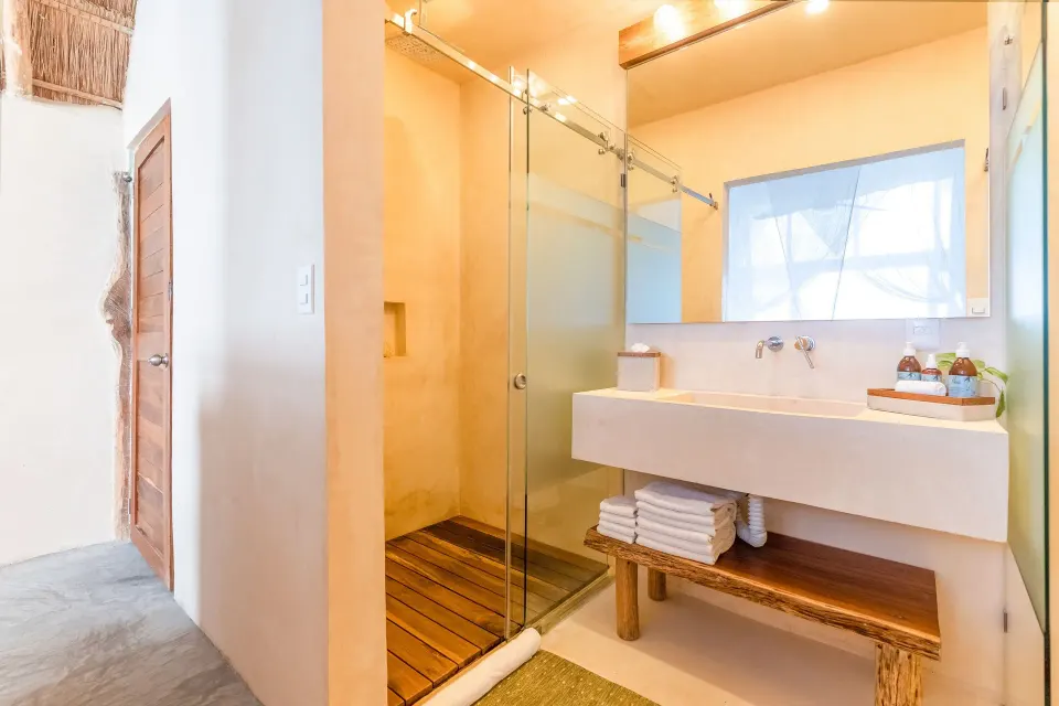 Bathroom vanity and glass shower stall in the Junior Suite at Ahau Tulum