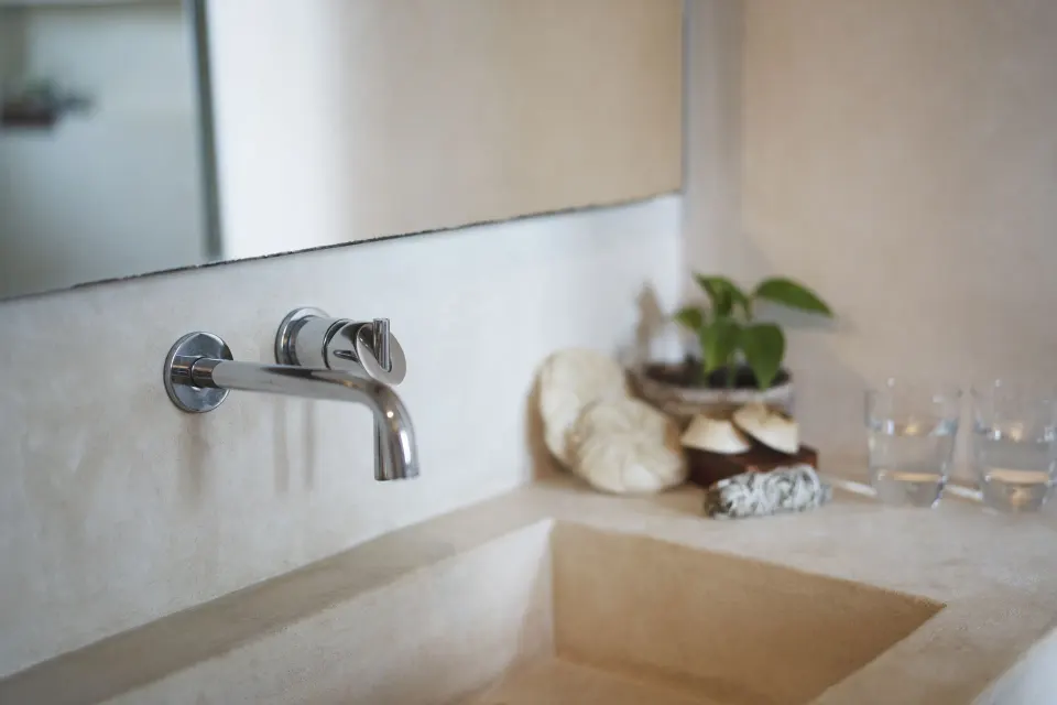 Wall-mounted bathroom faucet and sink in a Junior Suite at Ahau Tulum.