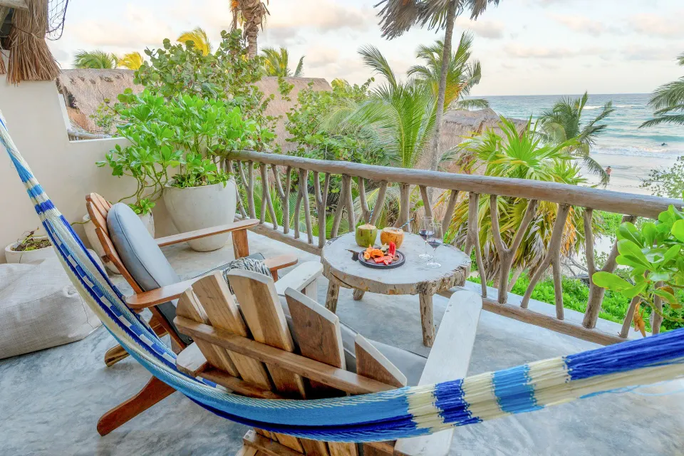 Balcony close-up with hammock and table set for snacks at Ahau Tulum