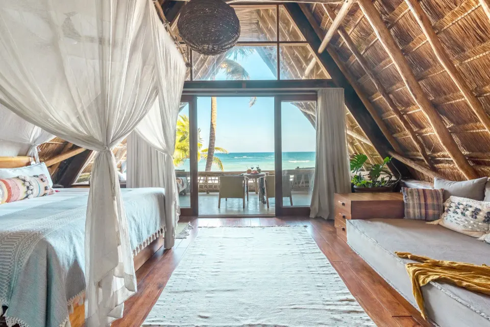 Master Suite interior looking toward the ocean terrace and palapa balcony at Ahau Tulum