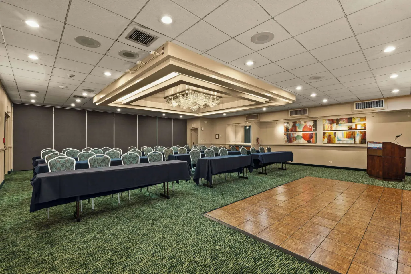 Meeting room with classroom seating, dance floor and podium at Airport Honolulu Hotel.