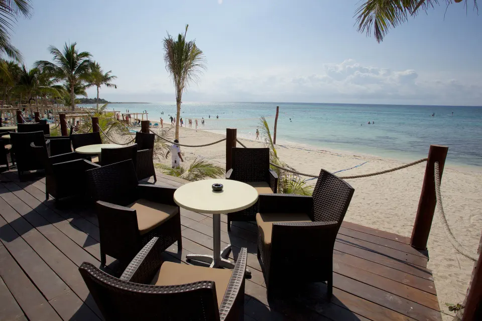 Deck seating looking over the hotel beach and ocean at Akumal Bay Beach & Wellness Resort