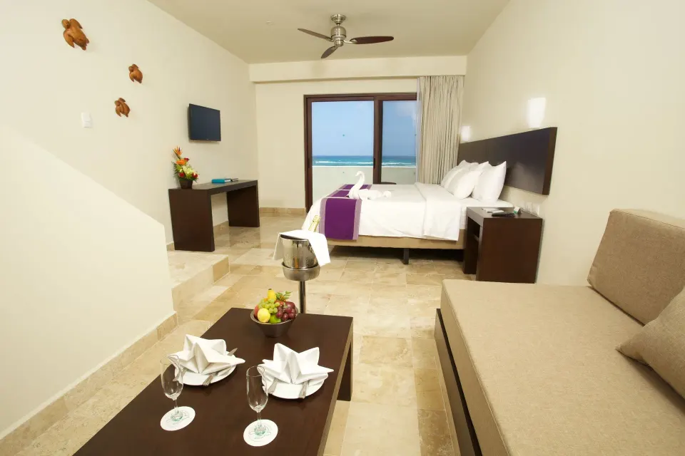 Junior suite with king bed and sea view at Akumal Bay Beach & Wellness Resort