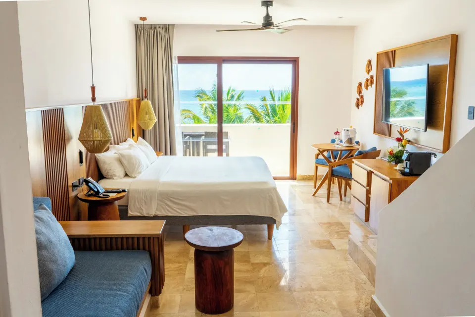 Junior Suite Penthouse bedroom with balcony and ocean view at Akumal Bay Beach & Wellness Resort
