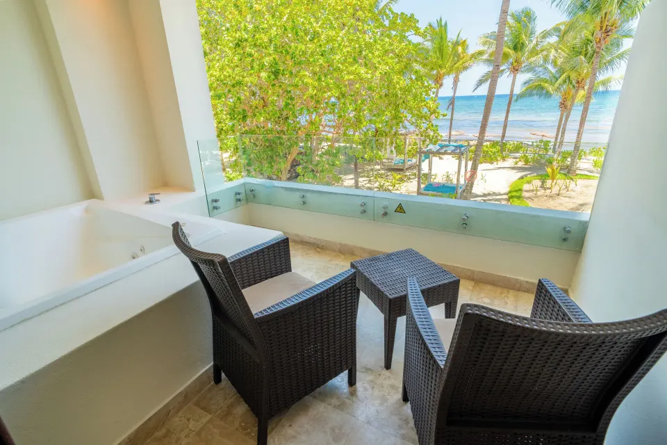 Balcony with chairs and partial sea view from Junior Suite at Akumal Bay Beach & Wellness Resort